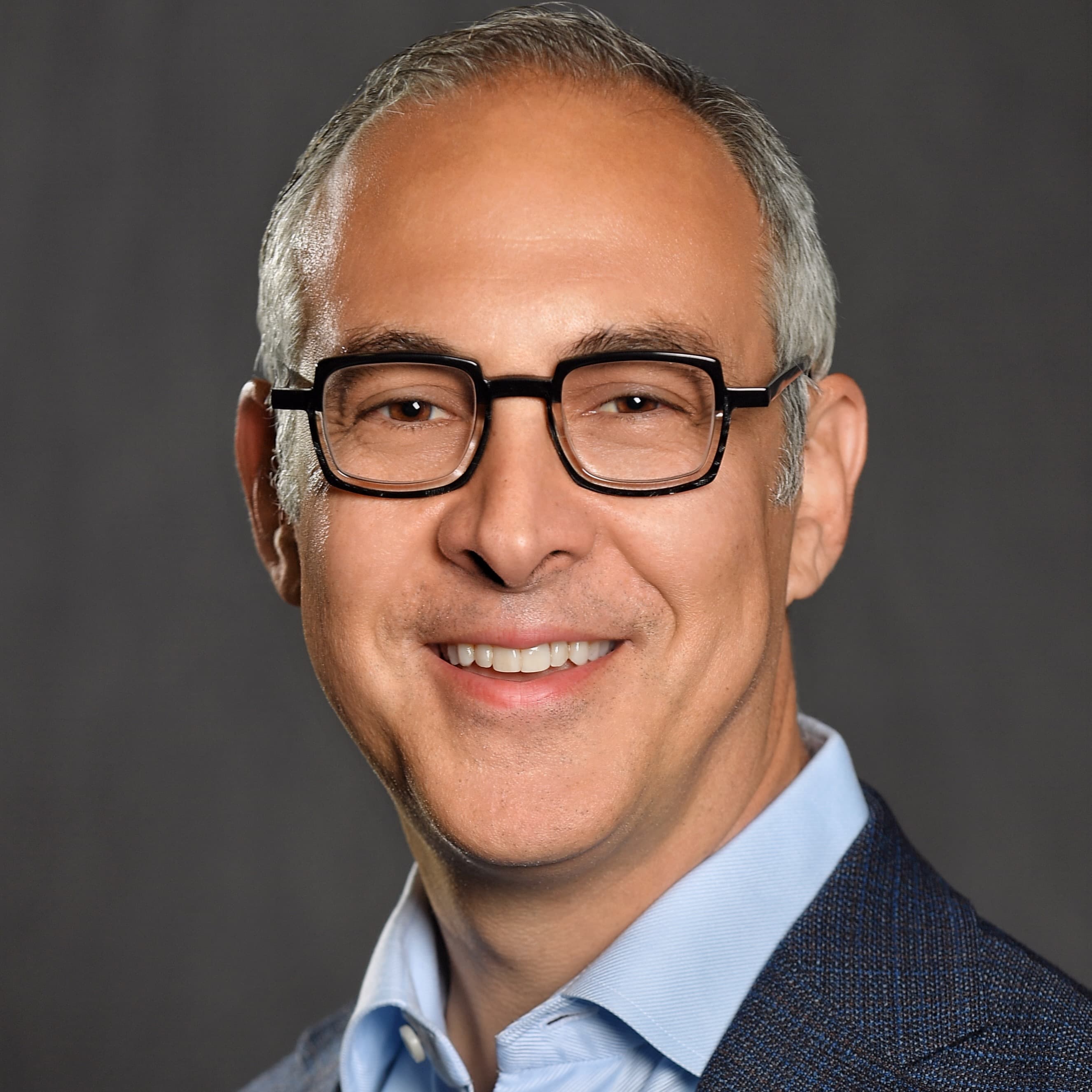 Tony Pisani wearing glasses in a square-cropped professional bio portrait.